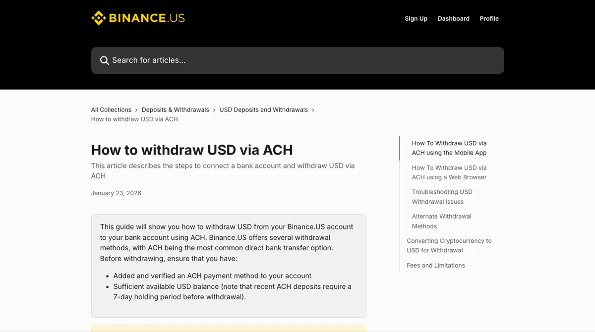 Binance.US 帮助中心「How to withdraw USD via ACH」页面顶部,日期 January 23, 2026,灰框里列出提现前要有已验证的 ACH 付款方式和足够的美元余额,并注明近期 ACH 存款要等 7 天,右侧目录有 Converting Cryptocurrency to USD for Withdrawal 与 Fees and Limitations 两节